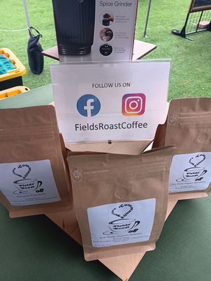 bags of fields roast coffee on a table at a market